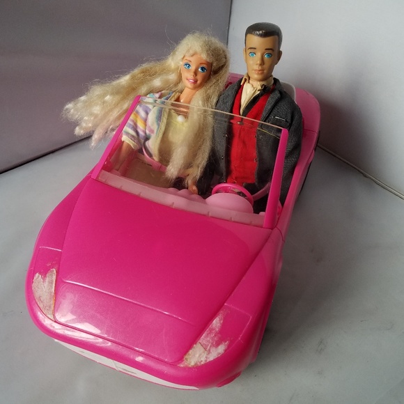 barbie doll and pink convertible